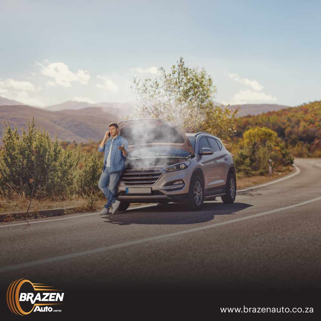 Man on the phone beside a smoking car on the roadside, showing engine failure and the need to sell a car as-is.